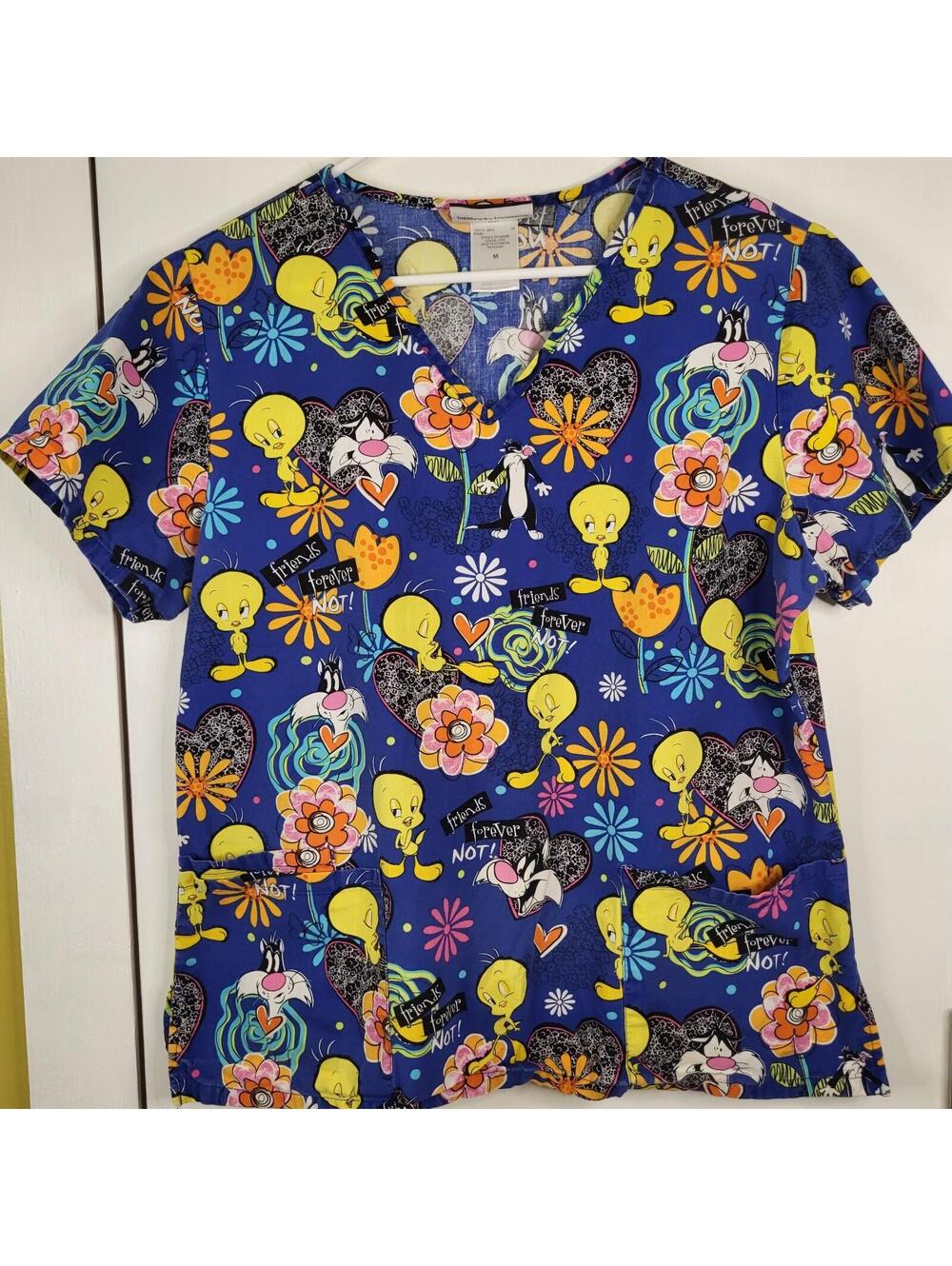 Looney Tunes scrub top bright blue background Tweety Bird and Sylvester the Cat
